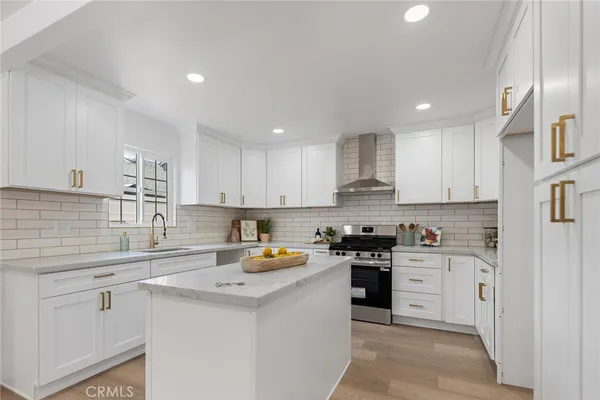 a kitchen with a sink a stove and cabinets
