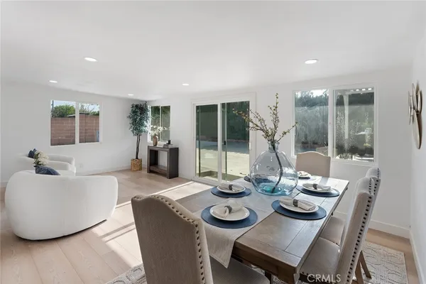 a view of a dining room with furniture wooden floor and chandelier