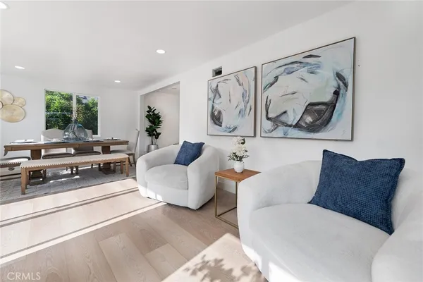a living room with furniture and a white wall