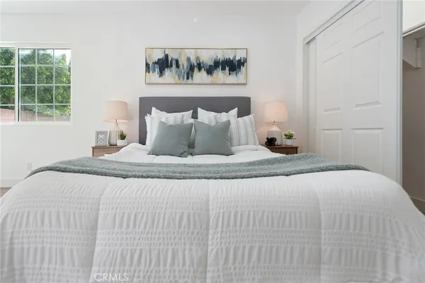 a bedroom with a bed and a window