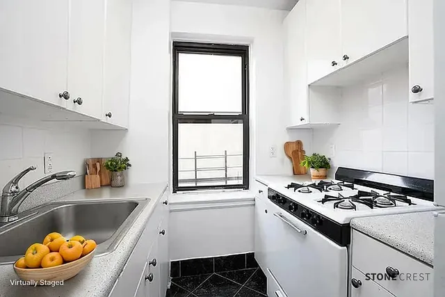 a kitchen with a sink appliances and cabinets