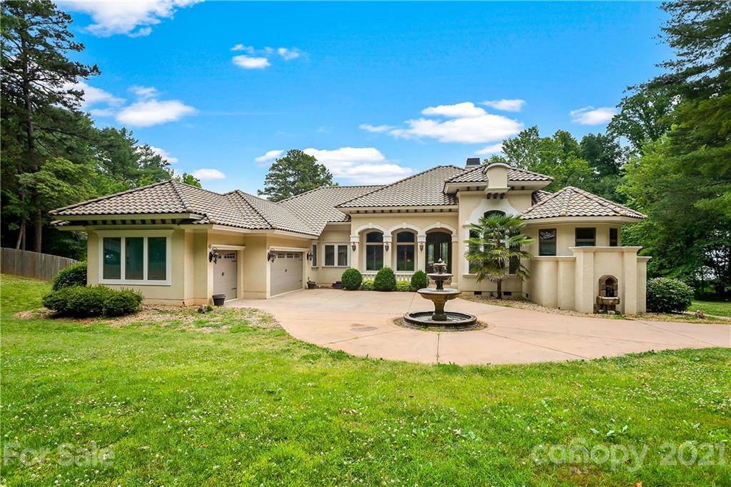 8891 Graham Point Lane Denver, NC 28037 - Photo 1 of 37 a patio with a table and chairs under an umbrella
