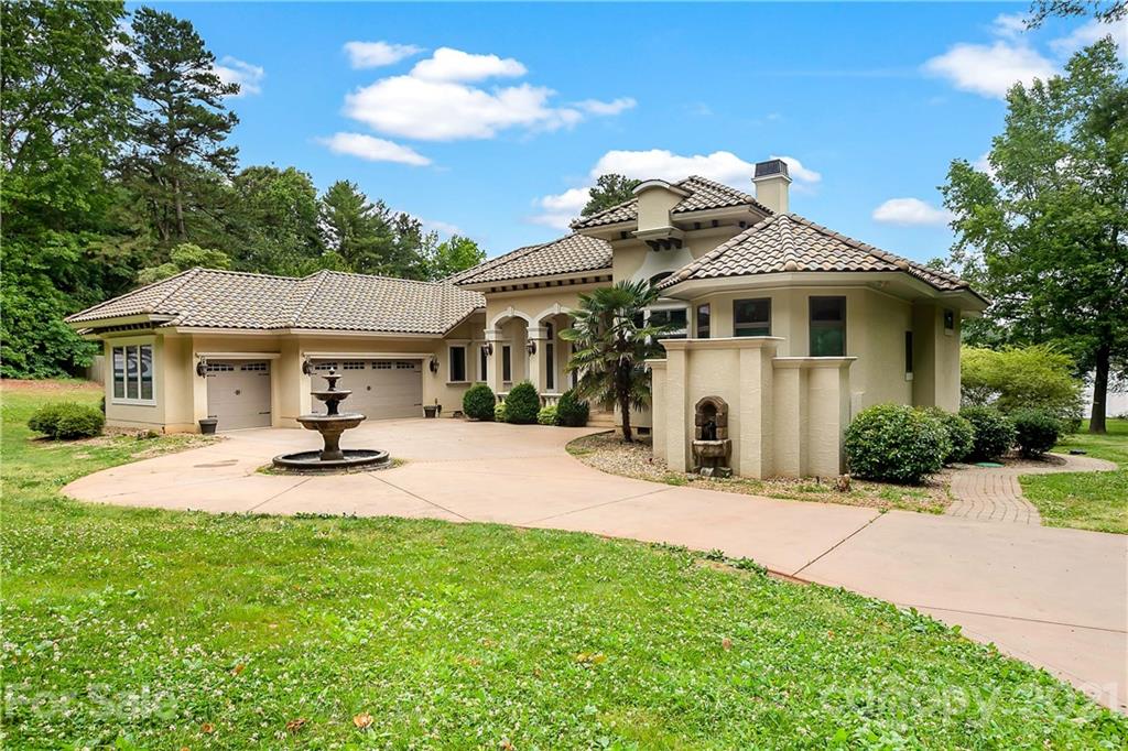 8891 Graham Point Lane Denver, NC 28037 - Photo 2 of 37 a front view of a house with swimming pool and porch