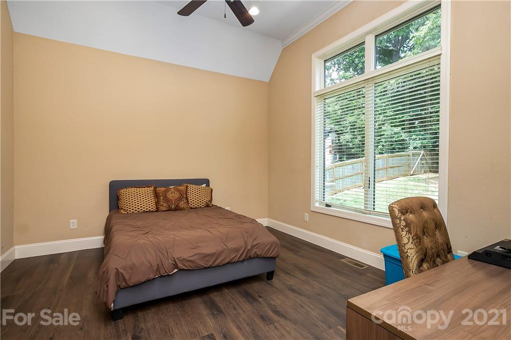 8891 Graham Point Lane Denver, NC 28037 - Photo 14 of 37 a bedroom with a bed and wooden floor