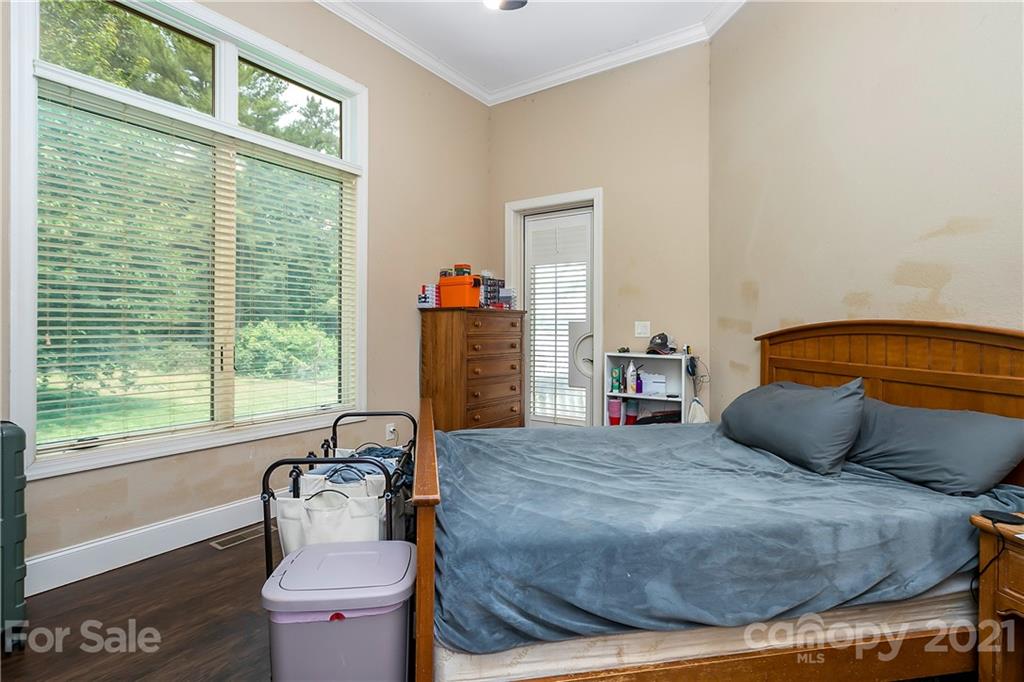 8891 Graham Point Lane Denver, NC 28037 - Photo 16 of 37 a bedroom with a bed and wooden floor