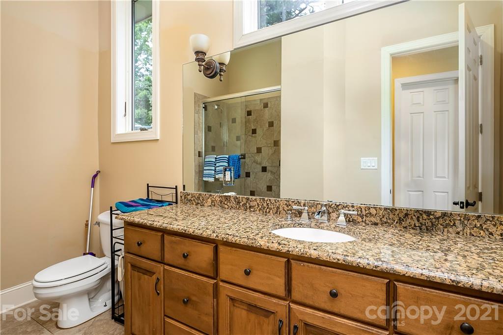 8891 Graham Point Lane Denver, NC 28037 - Photo 18 of 37 a bathroom with a granite countertop sink toilet and mirror