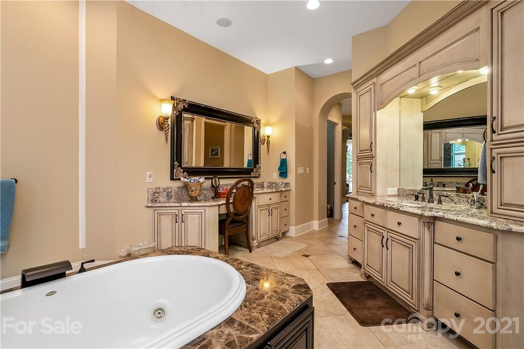 8891 Graham Point Lane Denver, NC 28037 - Photo 23 of 37 a large bathroom with a tub double sink and a mirror