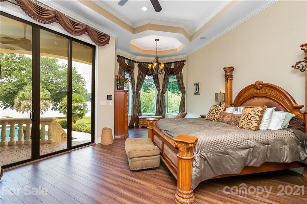 8891 Graham Point Lane Denver, NC 28037 - Photo 25 of 37 a bedroom with a bed and a large window with balcony view