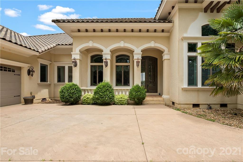 8891 Graham Point Lane Denver, NC 28037 - Photo 37 of 37 a view of a white house with a large windows and potted plants