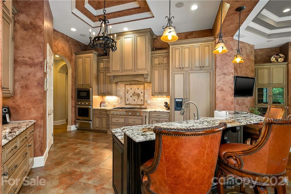 8891 Graham Point Lane Denver, NC 28037 - Photo 5 of 37 a kitchen with stainless steel appliances granite countertop a stove a sink and a refrigerator