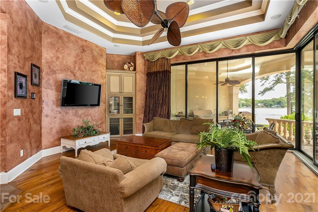 8891 Graham Point Lane Denver, NC 28037 - Photo 6 of 37 a living room with furniture a flat screen tv and a large window