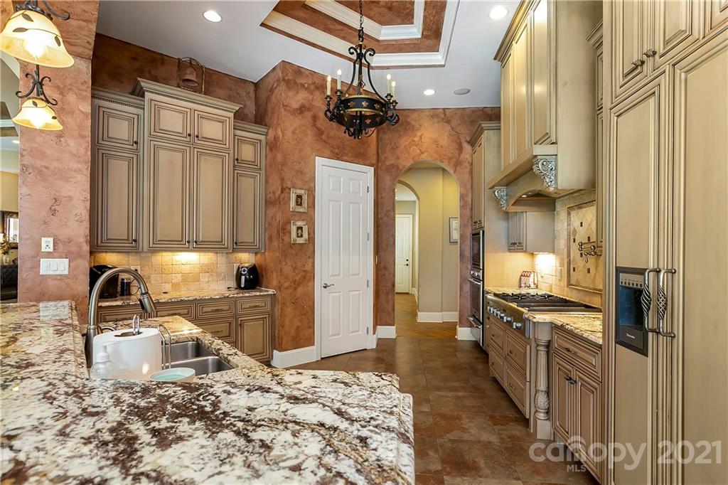 8891 Graham Point Lane Denver, NC 28037 - Photo 7 of 37 a kitchen with stainless steel appliances granite countertop a sink a stove and cabinets