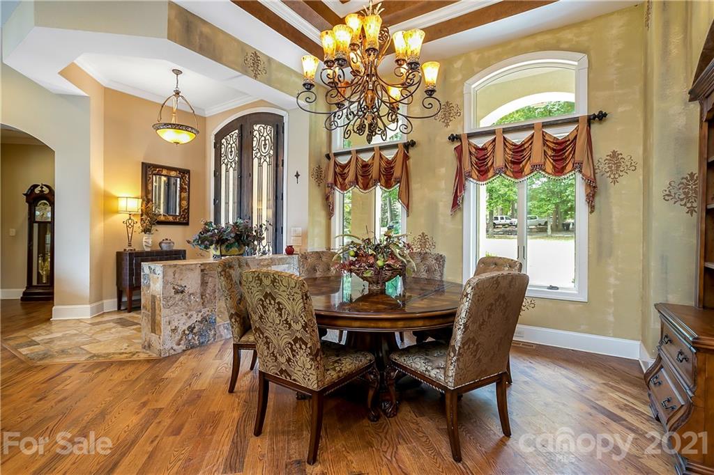 8891 Graham Point Lane Denver, NC 28037 - Photo 9 of 37 a view of a dining room with furniture a chandelier and wooden floor