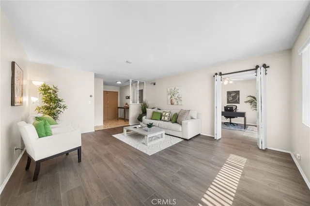 a living room with furniture and wooden floor
