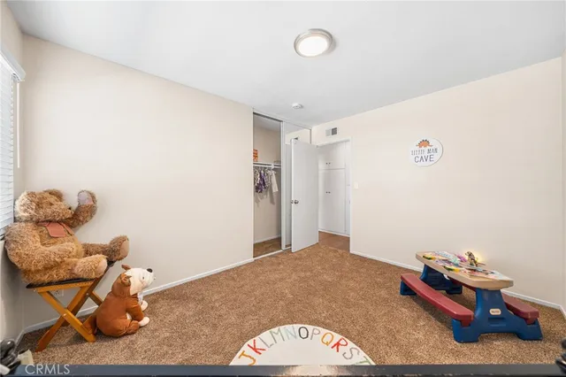 a living room with furniture large window and wooden floor