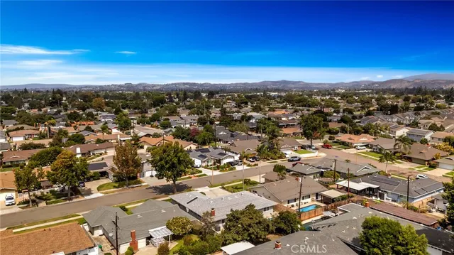 an aerial view of residential houses with city view