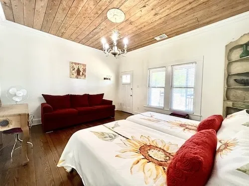 a bedroom with a bed and wooden floor