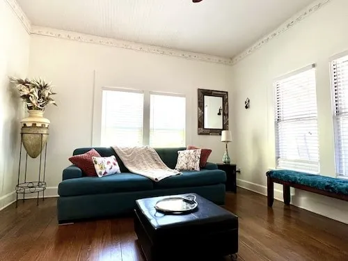a living room with furniture and wooden floor