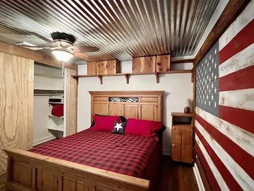 a bed room with a bed and a chandelier