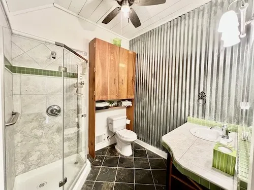 a bathroom with a sink toilet and shower