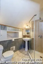 a view of a house with wooden fence