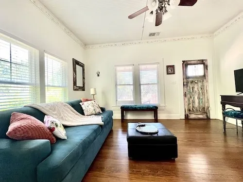 a bedroom with a bed couch and window