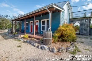 a backyard of a house with yard and outdoor seating