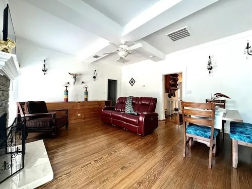 a living room with furniture and wooden floor