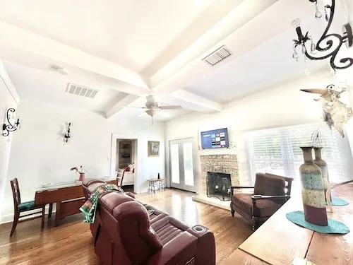 a living room with furniture a fireplace and a table
