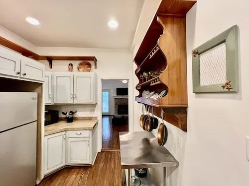 a kitchen with stainless steel appliances granite countertop a sink a stove and a refrigerator