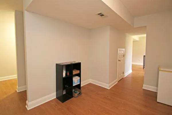 a view of an empty room and wooden floor