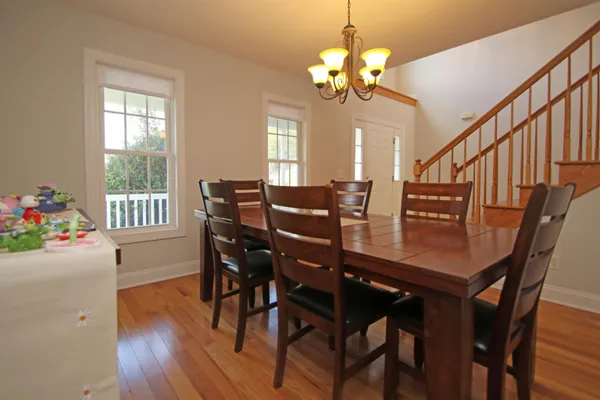 a view of a dining room with furniture and wooden floor