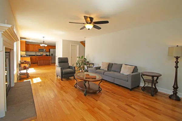a living room with patio furniture and a wooden floor