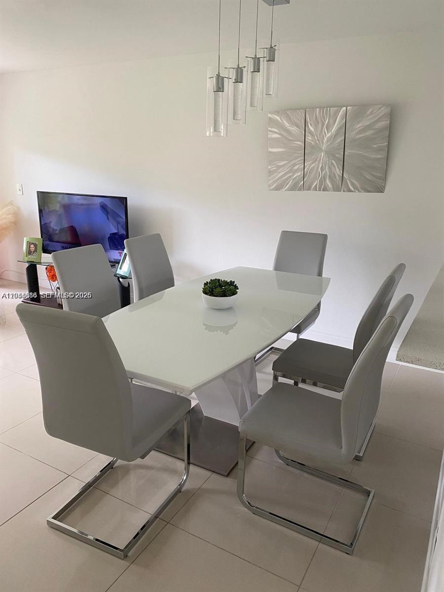 8838 West McNab Road, Unit 104 Tamarac, FL 33321 - Photo 2 of 23 a view of a dining room with furniture