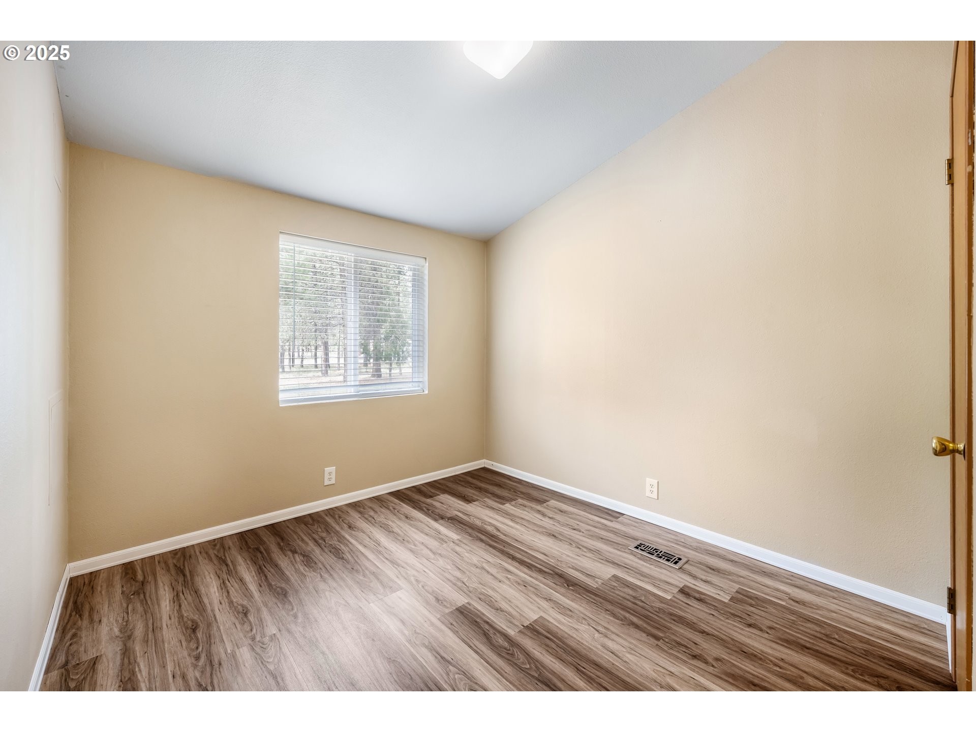 16173 North Drive La Pine, OR 97739 - Photo 11 of 23 a view of an empty room with wooden floor