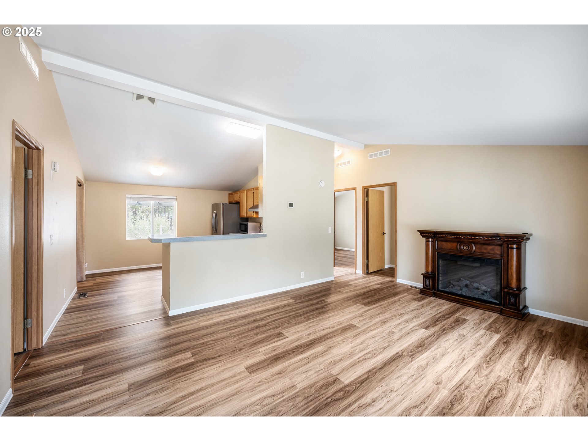 16173 North Drive La Pine, OR 97739 - Photo 5 of 23 a view interior of a house with wooden floor a fireplace and a window