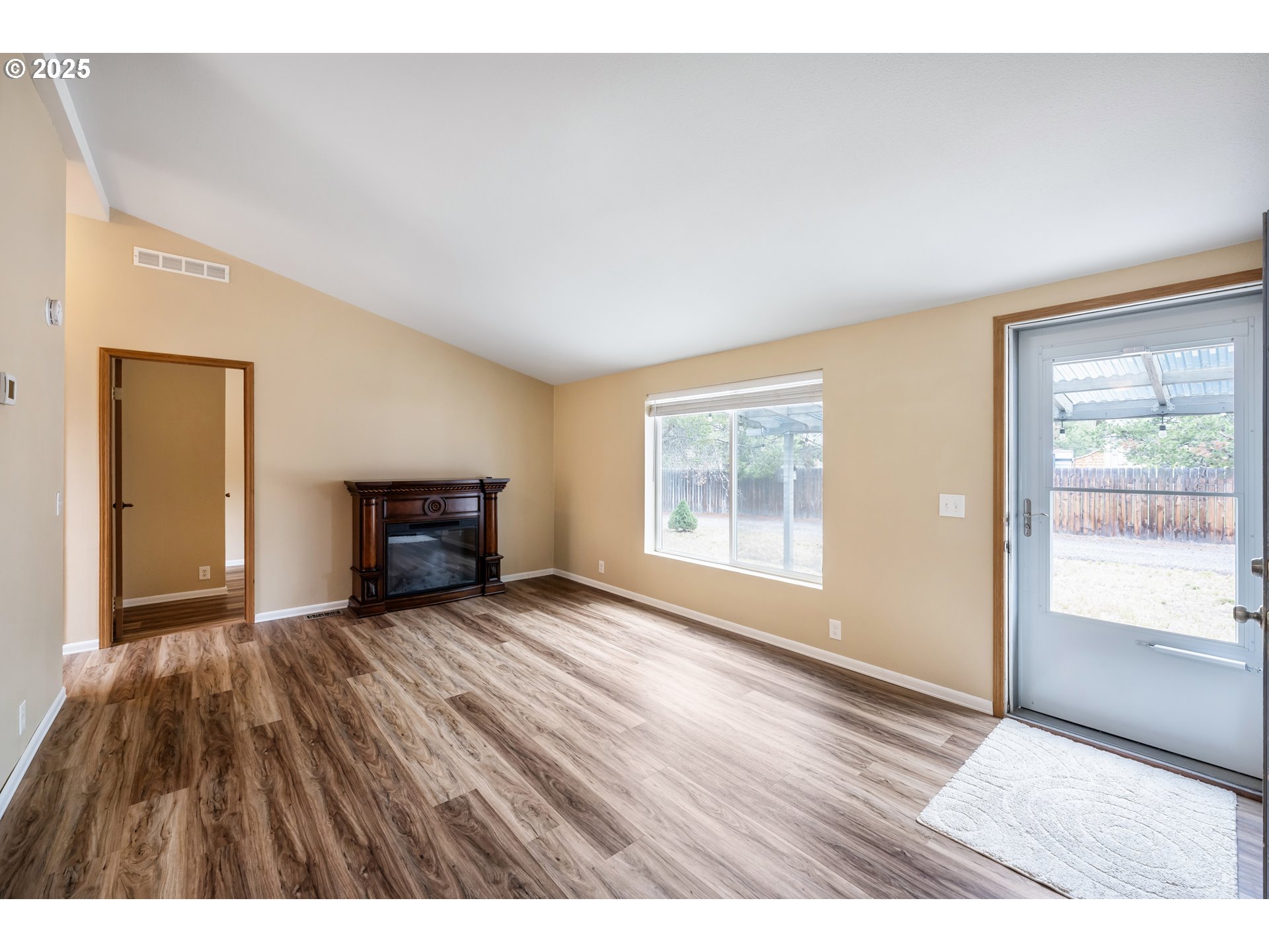 16173 North Drive La Pine, OR 97739 - Photo 6 of 23 a view of an empty room with glass door and wooden floor