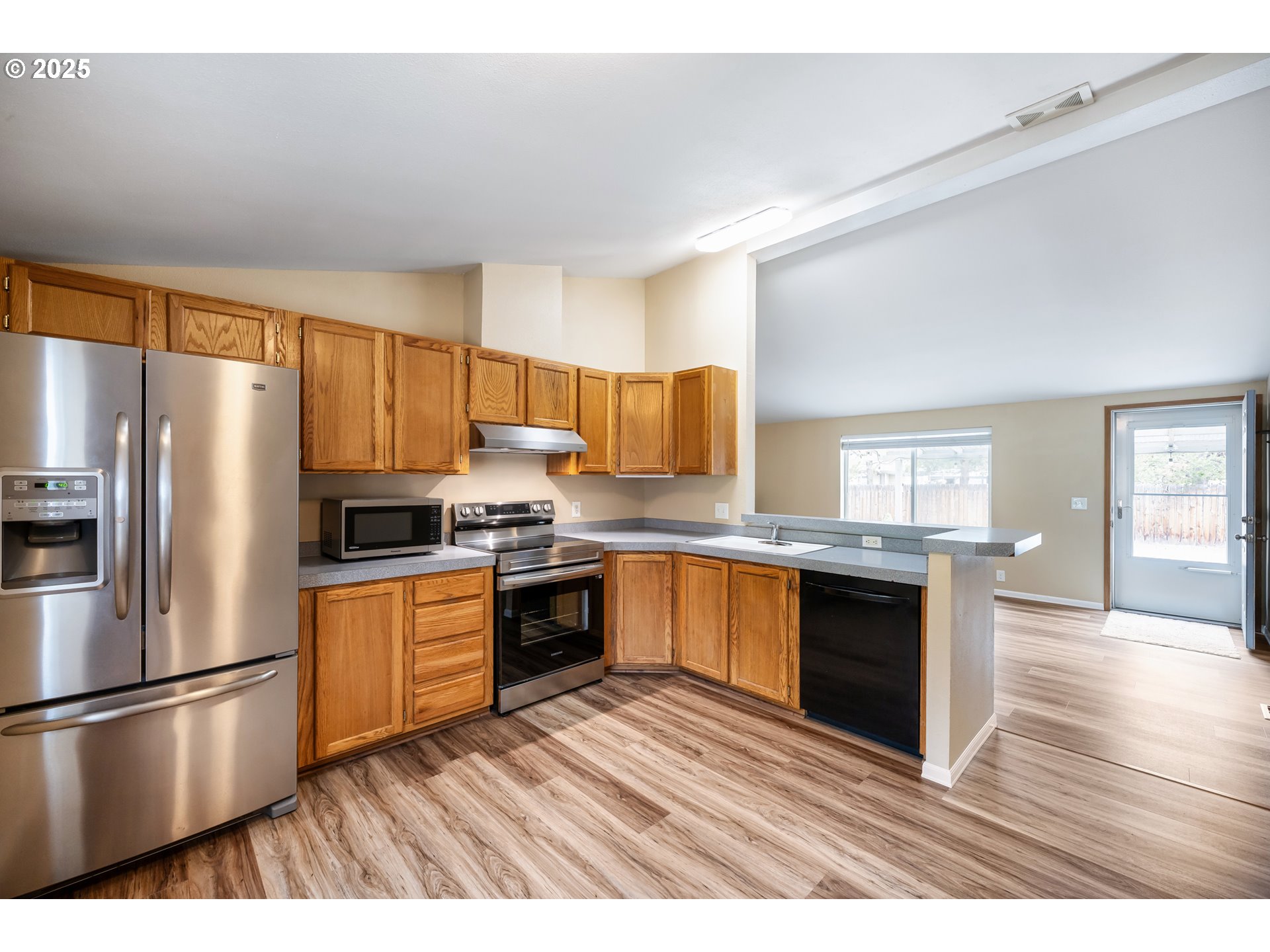 16173 North Drive La Pine, OR 97739 - Photo 7 of 23 a kitchen with granite countertop a refrigerator stove top oven and sink
