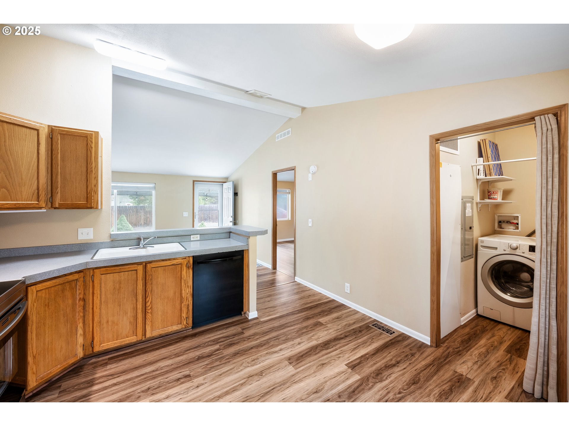 16173 North Drive La Pine, OR 97739 - Photo 8 of 23 a view interior of a kitchen with granite countertop a sink and dishwasher a stove with wooden floor