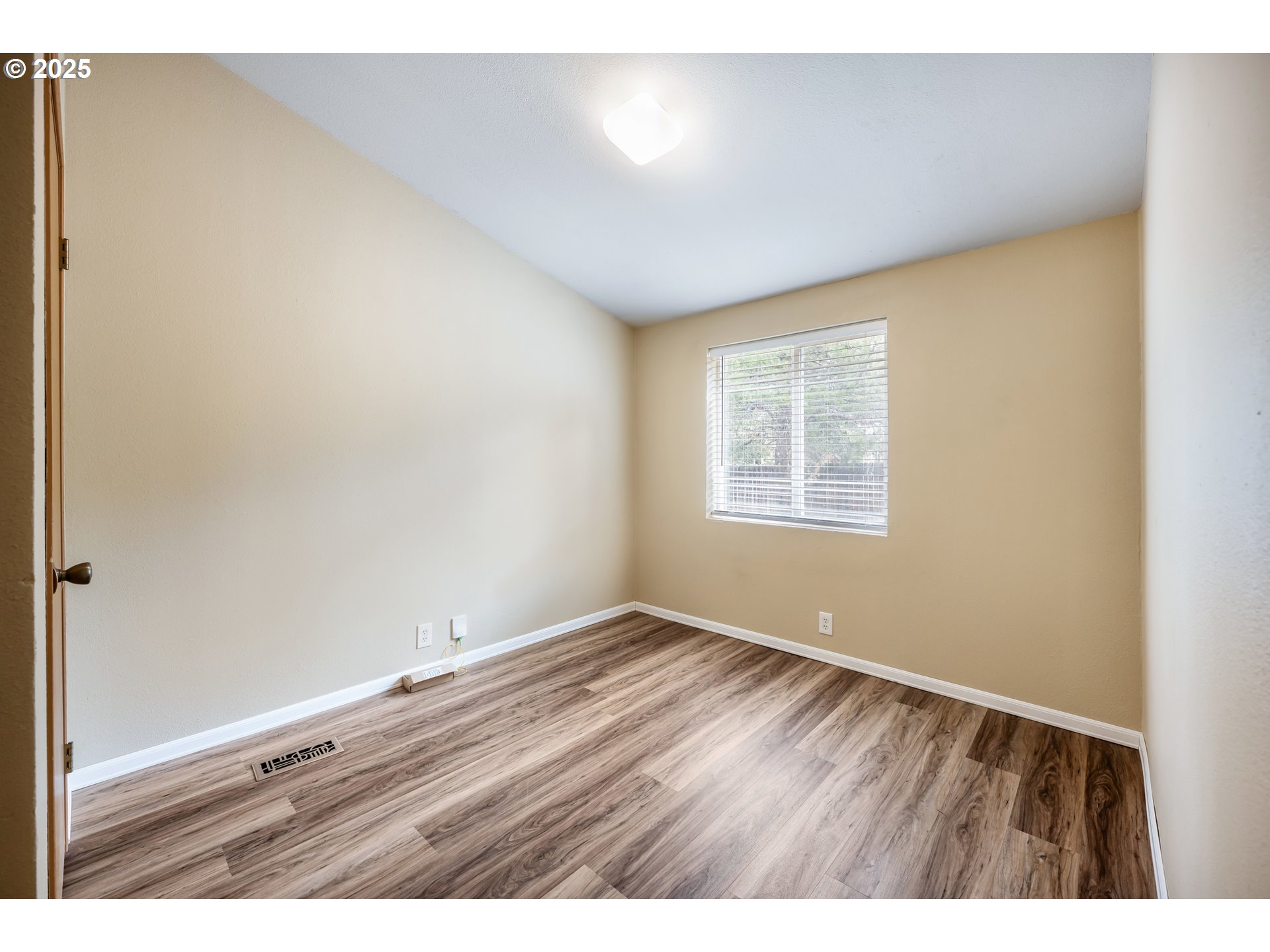 16173 North Drive La Pine, OR 97739 - Photo 9 of 23 an empty room with wooden floor and windows