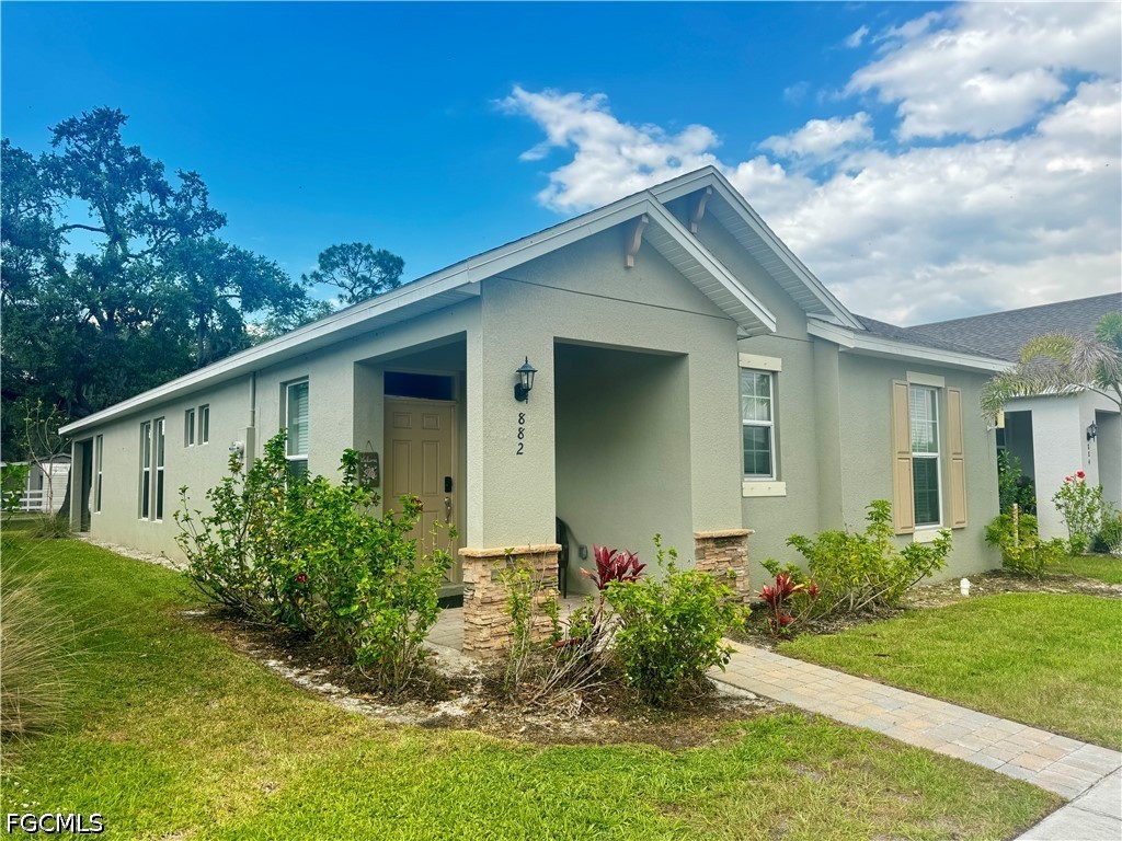 882 Friendship Circle LaBelle, FL 33935 - Photo 1 of 37 a front view of house with yard and trees around