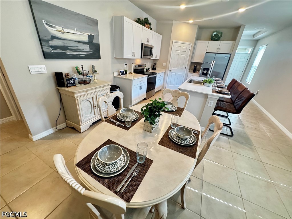 882 Friendship Circle LaBelle, FL 33935 - Photo 13 of 37 a view of a workspace with furniture and a flat screen tv