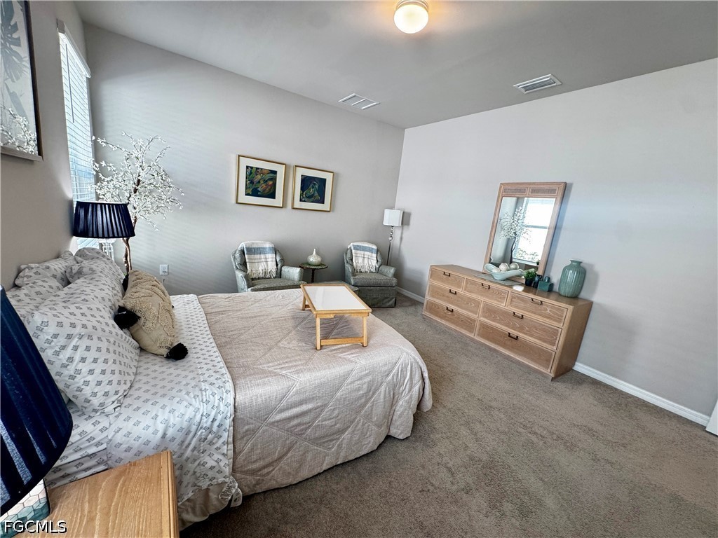 882 Friendship Circle LaBelle, FL 33935 - Photo 20 of 37 a bedroom with bed and a couch