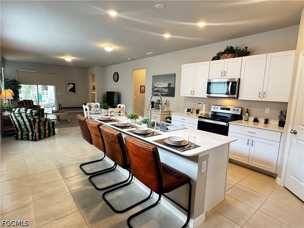 882 Friendship Circle LaBelle, FL 33935 - Photo 2 of 37 a kitchen with a sink stove and cabinets