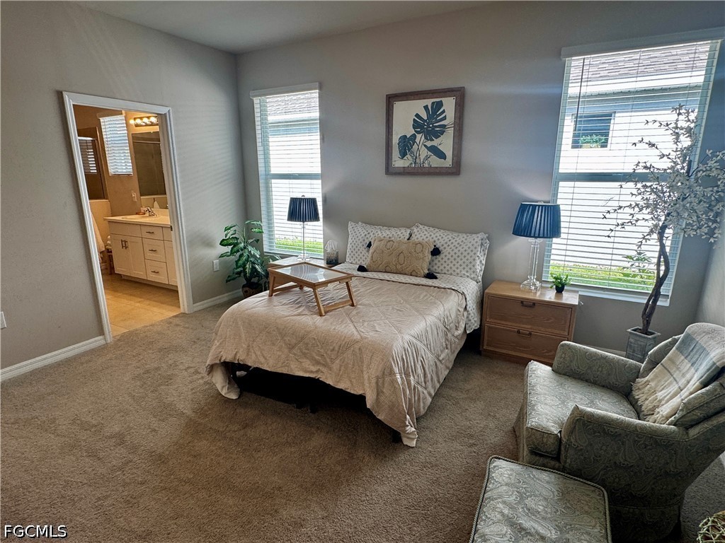 882 Friendship Circle LaBelle, FL 33935 - Photo 22 of 37 a spacious bedroom with a bed couch and a window