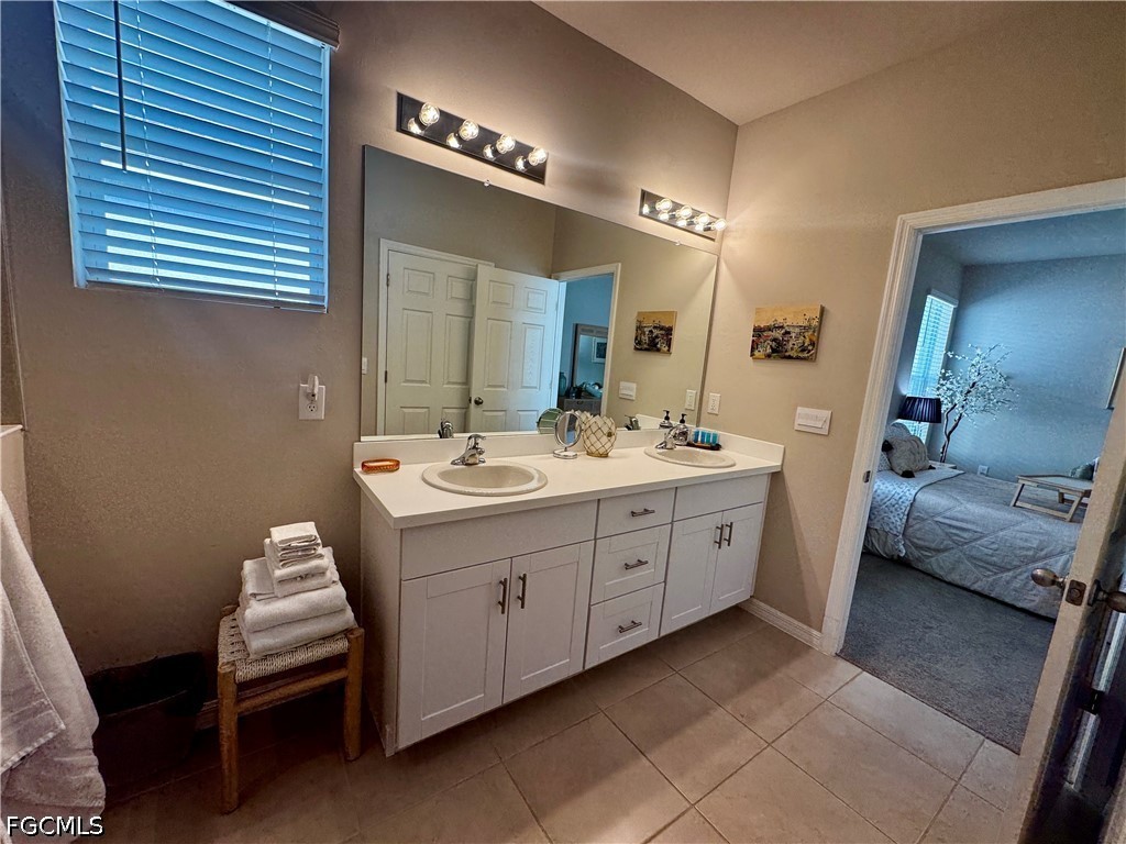 882 Friendship Circle LaBelle, FL 33935 - Photo 25 of 37 a bathroom with a double vanity sink and a mirror