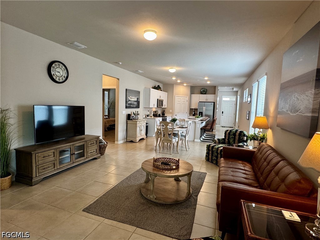882 Friendship Circle LaBelle, FL 33935 - Photo 3 of 37 a living room with furniture and a flat screen tv