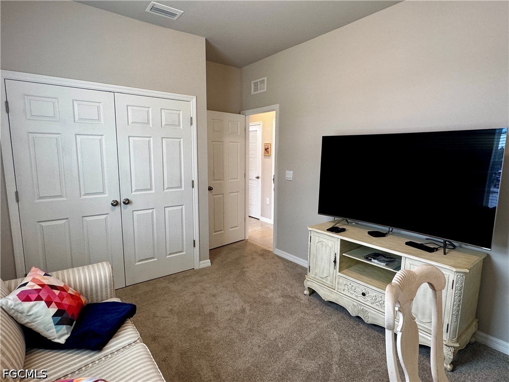 882 Friendship Circle LaBelle, FL 33935 - Photo 32 of 37 a living room with furniture and a flat screen tv