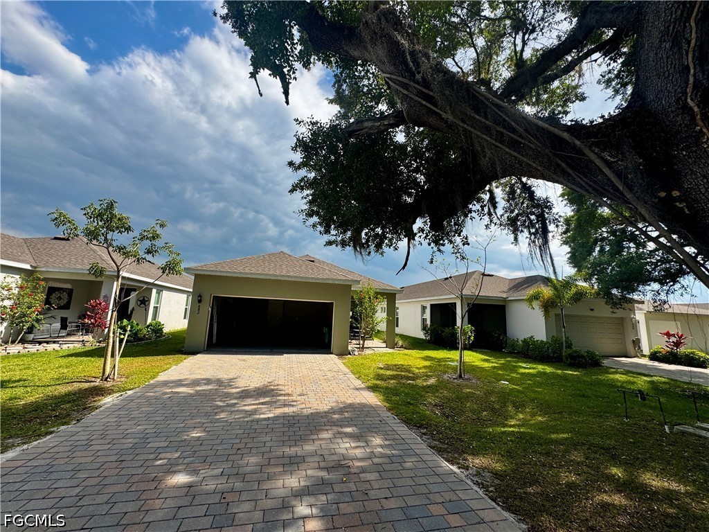 882 Friendship Circle LaBelle, FL 33935 - Photo 33 of 37 a front view of a house with a yard