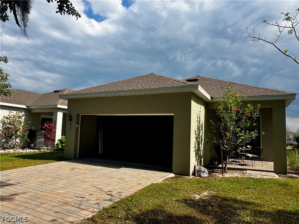 882 Friendship Circle LaBelle, FL 33935 - Photo 34 of 37 a front view of a house with a yard